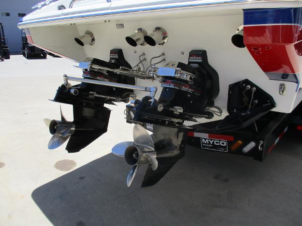 Slide: The Image of 1997 Formula 382 FASTech boat with dual outboard motors on a trailer. - 8