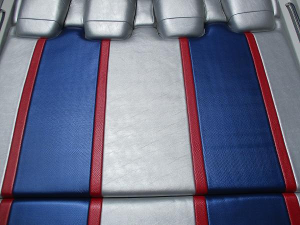 Slide: The Image of 1997 Formula 382 FASTech boat seat with blue, red, and silver upholstery. - 9