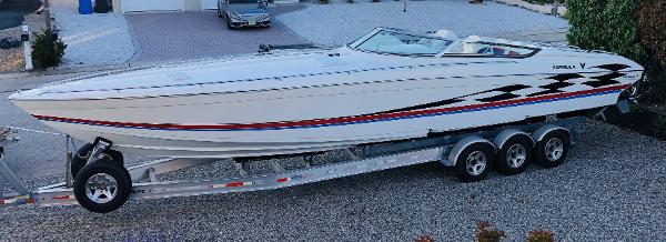 Slide: The Image of 2000 Formula 382 FASTech speedboat on a trailer, featuring sleek design and vibrant graphics. - 0