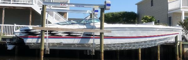 Slide: The Image of 2000 Formula 382 FASTech boat on lift, docked near waterfront homes. - 18