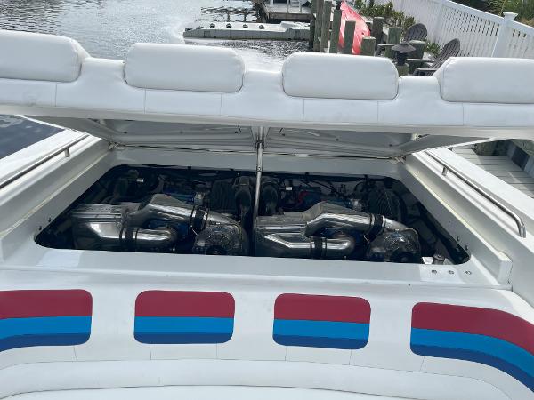 Slide: The Image of 2000 Formula 382 FASTech boat engine compartment with dual engines, open hatch, and colorful exterior design. - 19