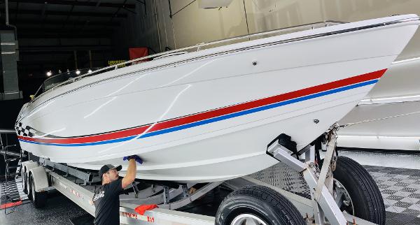 Slide: The Image of 2000 Formula 382 FASTech boat on trailer, white with red and blue stripes, in a garage. - 25