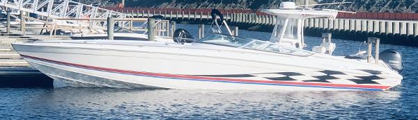 Slide: The Image of 2000 Formula 382 FASTech boat docked at marina, featuring sleek design and checkered graphics. - 26