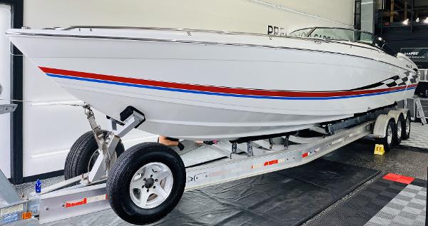 Slide: The Image of 2000 Formula 382 FASTech boat on trailer, white with red and blue stripes. - 28