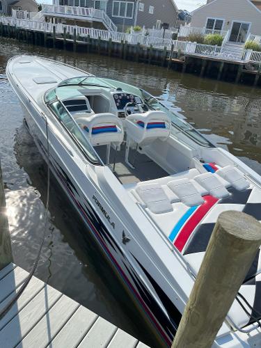 Slide: The Image of 2000 Formula 382 FASTech boat docked by waterfront homes. - 9