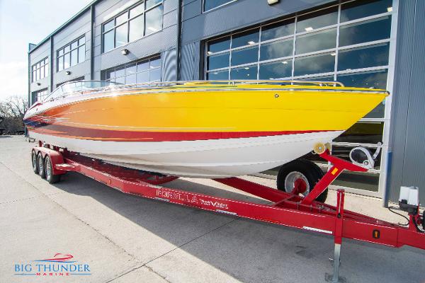 Slide: The Image of 2012 Formula 382 FASTech boat on red trailer outside Big Thunder Marine. - 1
