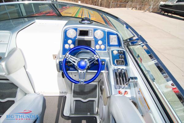 Slide: The Image of 2012 Formula 382 FASTech boat cockpit with blue steering wheel and control panel. - 17