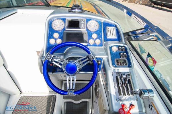 Slide: The Image of 2012 Formula 382 FASTech boat dashboard with blue steering wheel and control panel. - 18