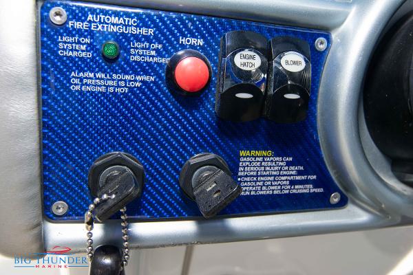Slide: The Image of Control panel of a 2012 Formula 382 FASTech boat with fire extinguisher and engine controls. - 23