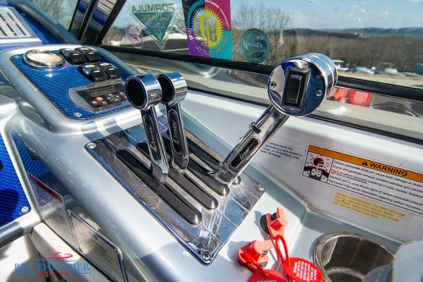 Slide: The Image of 2012 Formula 382 FASTech boat control panel with throttle and gear levers. - 27