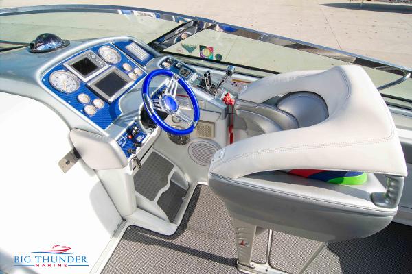 Slide: The Image of 2012 Formula 382 FASTech boat cockpit with blue steering wheel and advanced dashboard. - 29