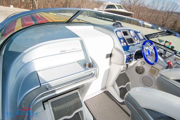 Slide: The Image of 2012 Formula 382 FASTech boat cockpit with modern controls and blue steering wheel. - 41