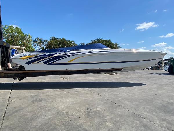Slide: The Image of 2013 Formula 382 FASTech speedboat on a lift, blue and yellow accents. - 0