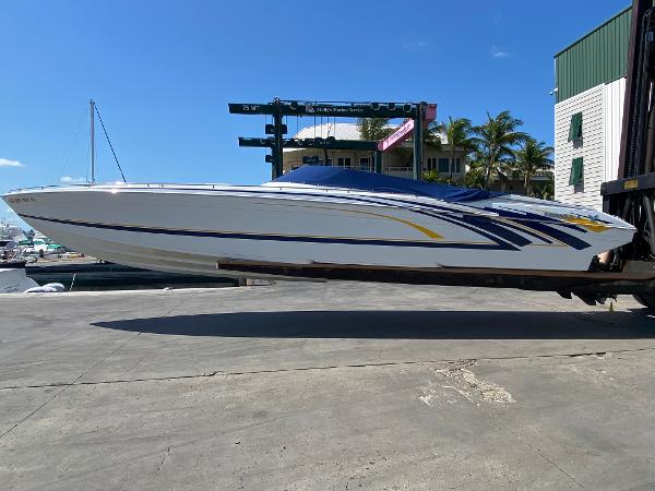 Slide: The Image of 2013 Formula 382 FASTech speedboat on a lift at a marina. - 1