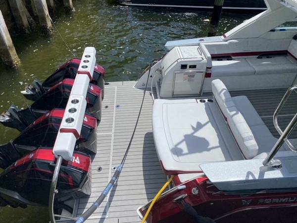 Slide: The Image of 2020 Formula 430 Super Sport Crossover boat with quad outboard engines docked. - 15