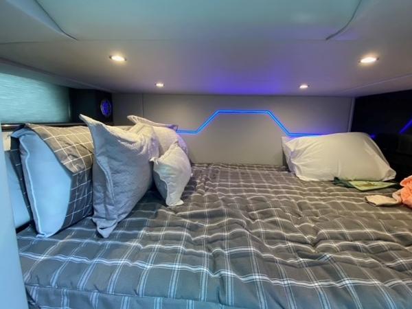 Slide: The Image of 2020 Formula 430 Super Sport Crossover cabin bed with modern lighting and cozy bedding. - 16