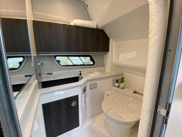 Slide: The Image of 2020 Formula 430 Super Sport Crossover bathroom with modern fixtures and storage cabinets. - 17