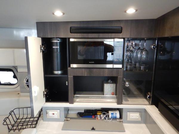 Slide: The Image of 2020 Formula 430 Super Sport Crossover kitchen with microwave and storage cabinets. - 19