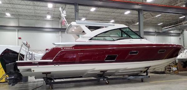 Slide: The Image of 2020 Formula 430 Super Sport Crossover boat in a showroom. - 2