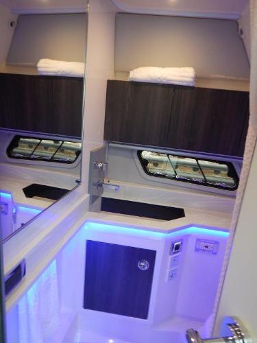 Slide: The Image of 2020 Formula 430 Super Sport Crossover bathroom with modern fixtures and ambient lighting. - 23