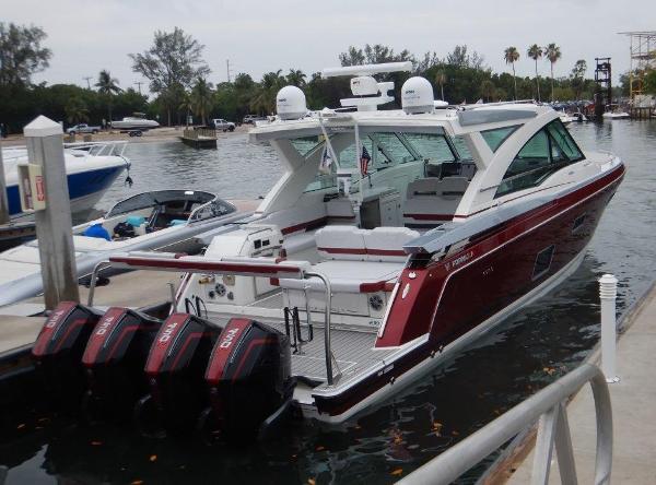 Slide: The Image of 2020 Formula 430 Super Sport Crossover boat docked with triple outboard engines. - 3