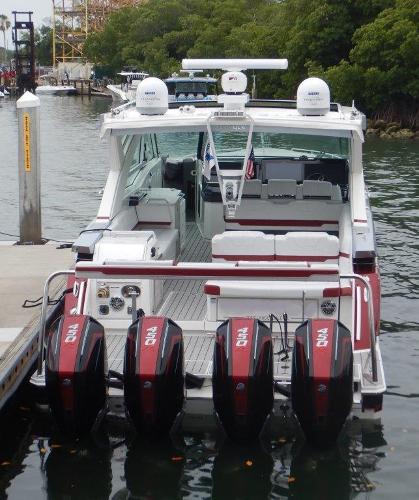 Slide: The Image of 2020 Formula 430 Super Sport Crossover boat docked with quad outboard engines. - 4