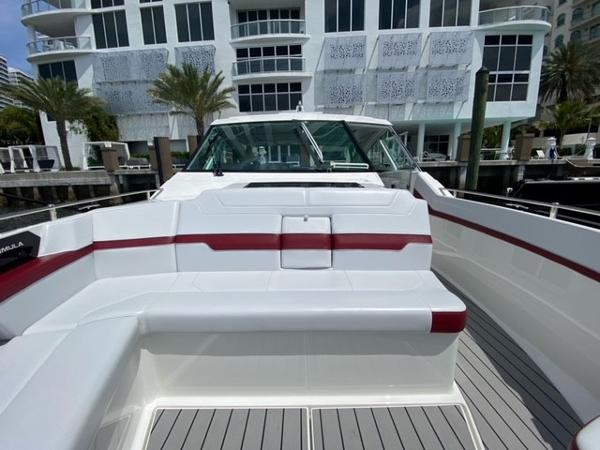 Slide: The Image of 2020 Formula 430 Super Sport Crossover boat docked near modern building. - 9