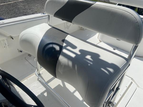Slide: The Image of 2004 Fountain 34 CC boat seating with white and gray upholstery. - 17