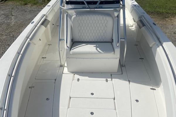 Slide: The Image of 2004 Fountain 34 CC boat interior with white seating and spacious deck. - 25