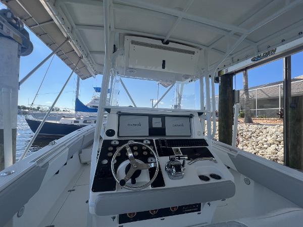 Slide: The Image of 2008 Fountain 34 CC boat cockpit with steering wheel and navigation equipment. - 13