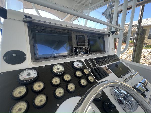 Slide: The Image of 2008 Fountain 34 CC boat dashboard with gauges and navigation screens. - 15
