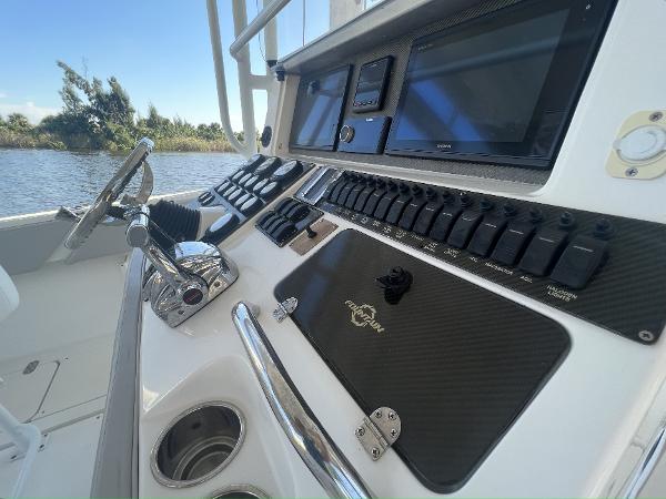 Slide: The Image of 2008 Fountain 34 CC boat dashboard with controls and navigation screens. - 16