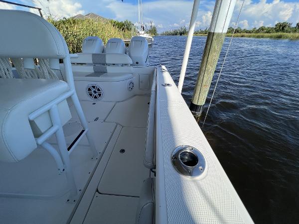 Slide: The Image of 2008 Fountain 34 CC boat interior, white seating, on calm water. - 18