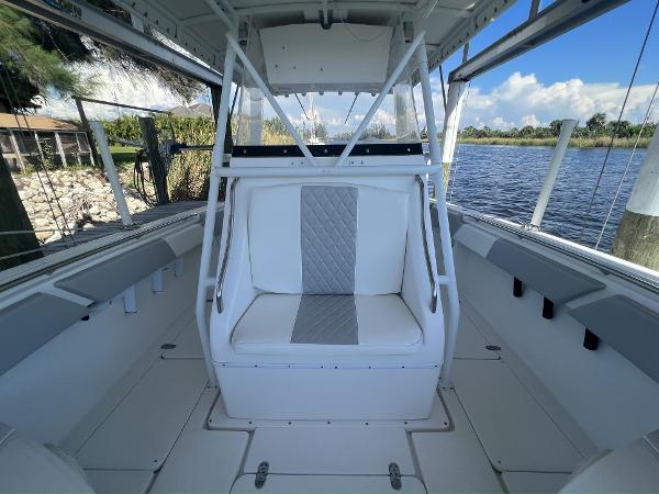 Slide: The Image of 2008 Fountain 34 CC boat interior with white seating and open water view. - 21