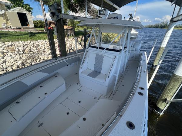 Slide: The Image of 2008 Fountain 34 CC boat docked by a serene lakeside. - 23