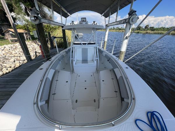 Slide: The Image of 2008 Fountain 34 CC boat docked under canopy on a sunny day. - 24