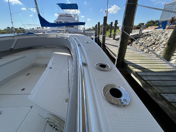 Slide: The Image of 2008 Fountain 34 CC boat docked, showcasing sleek design and spacious deck. - 26
