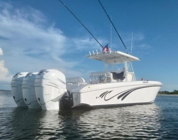 Slide: The Image of 2008 Fountain 34 CC boat with triple Mercury engines on calm water. - 3