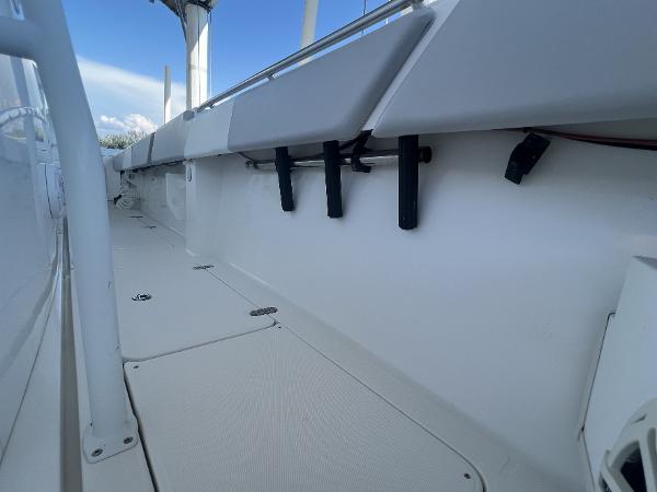 Slide: The Image of 2008 Fountain 34 CC boat interior with rod holders and sleek white design. - 30