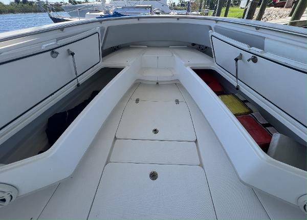 Slide: The Image of 2008 Fountain 34 CC boat interior with storage compartments and seating. - 36
