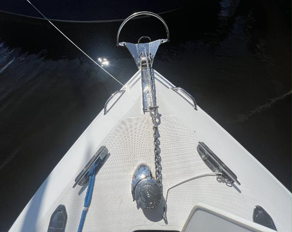 Slide: The Image of Bow of 2008 Fountain 34 CC boat with anchor chain and calm water. - 37