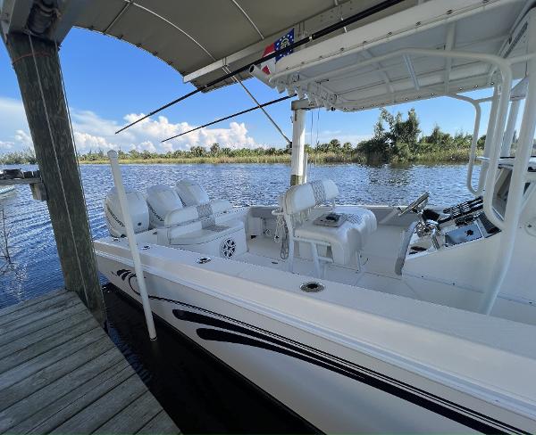 Slide: The Image of 2008 Fountain 34 CC boat docked by a serene lake under a clear sky. - 5