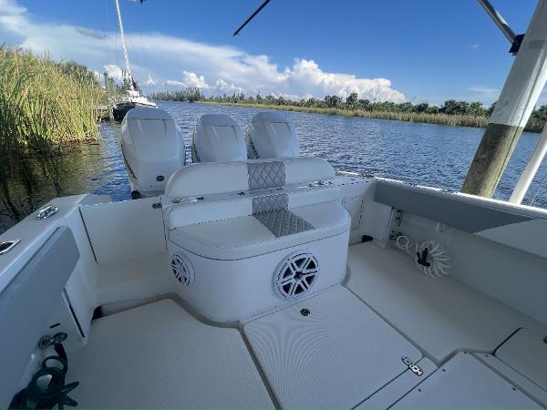 Slide: The Image of 2008 Fountain 34 CC boat interior with seating, speakers, and scenic water view. - 6