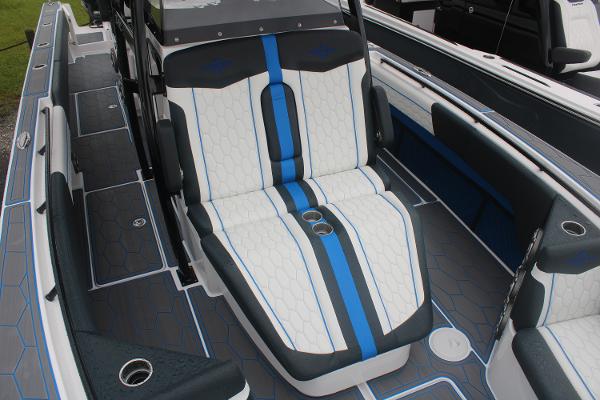Slide: The Image of 2024 Fountain 34 SC boat interior with white and blue seating. - 12