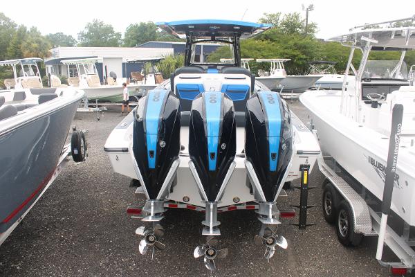 Slide: The Image of 2024 Fountain 34 SC boat with triple outboard engines, rear view. - 14