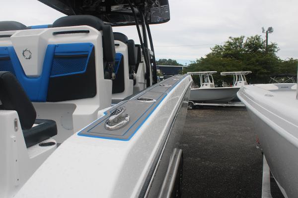 Slide: The Image of 2024 Fountain 34 SC boat interior with blue and white seating. - 17