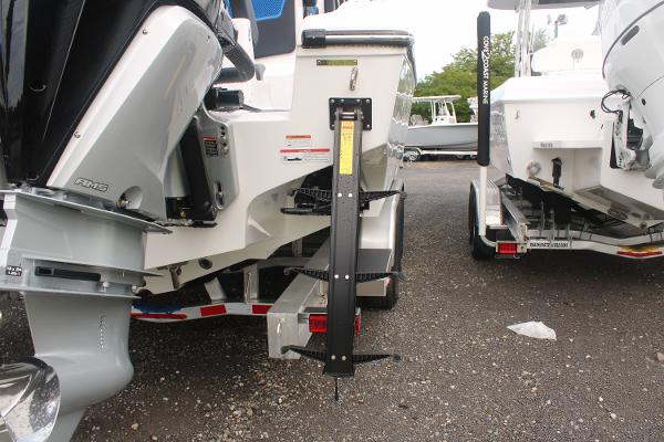 Slide: The Image of 2024 Fountain 34 SC boat rear view with outboard motors and trailer. - 18