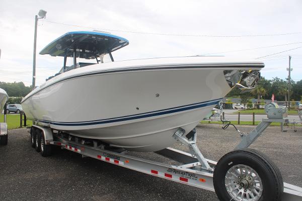 Slide: The Image of 2024 Fountain 34 SC boat on a trailer in a parking lot. - 2