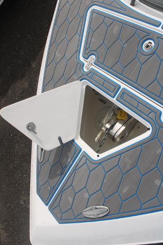 Slide: The Image of 2024 Fountain 34 SC boat anchor compartment with hexagonal deck pattern. - 21