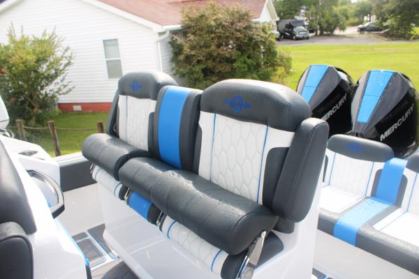 Slide: The Image of Luxury seating on 2024 Fountain 34 SC boat with Mercury engines in background. - 24